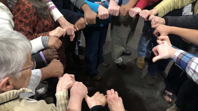 Friends forming a circle of hands