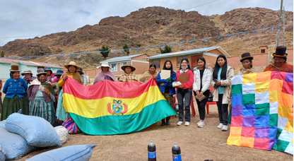 A colorful group of Bolivians holding banners