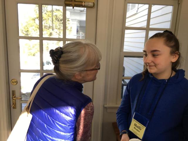 A woman talking to a young girl