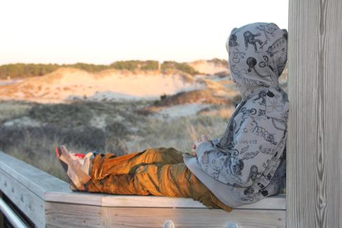 JYM child on beach fence