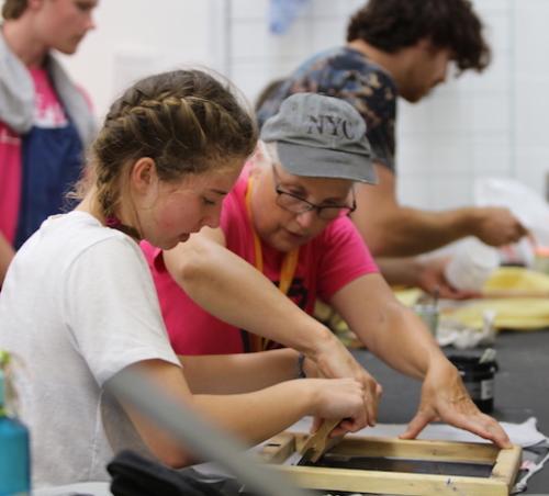 staff person teaching silk screening