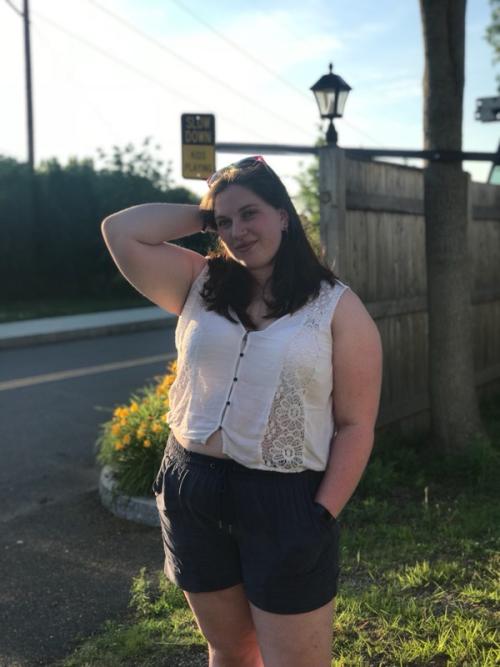 Kenzie in front of a fence and streetlight 